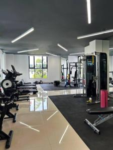 a gym with several treadmills and machines in a room at Exclusive Apartment in Home Resort in La Cañada