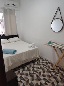a bedroom with a bed and a mirror and a checkered floor at Aconchego e tranquilidade é aqui!!!! Te aguardo! in Porto Seguro