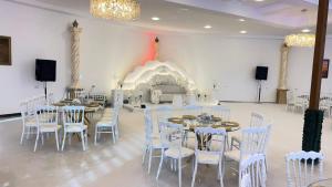 a banquet hall with tables and chairs and a fireplace at Petra Seasons luxury Resort in Al Ḩayy +172 photos