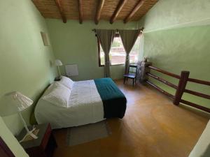 a bedroom with a bed and a wooden floor at Balcones del Pintor in Maimará
