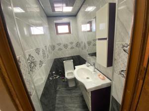 a small bathroom with a sink and a toilet at Qusar Villa in Uzunmeşǝ +19 photos