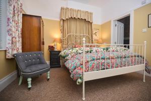 a bedroom with a bed and a chair at The Forester and Flower in Bath +30 photos