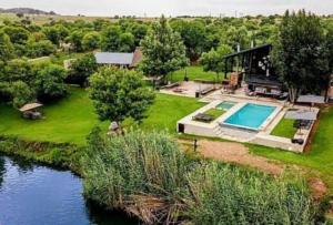an aerial view of a house with a swimming pool at Marble Nights Damoi Parys in Vosburg