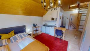 a bedroom with a bed and a kitchen with a table at Apartment Schlager Maria in Pirkach