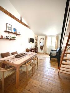 a living room with a wooden table and a couch at Maison atypique - Au coeur de la vieille ville in Le Puy-en-Velay