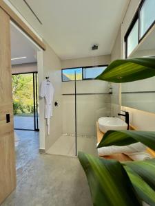 a bathroom with a white shirt hanging on the wall at Glamping Del Río by Trip Monkey in San Gil +22 photos