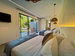 a bedroom with a large bed and a large window at Glamping Del Río by Trip Monkey in San Gil