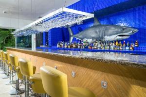 a bar with a shark projected on the wall at Ocean Breeze Nuevo Vallarta in Nuevo Vallarta +1 photo