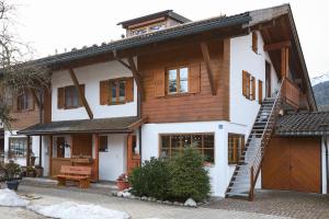 a wooden house with a staircase in front of it at Bergliebe Alpspitze in Garmisch-Partenkirchen