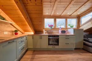 a kitchen in a log cabin with a stove at Bergliebe Alpspitze in Garmisch-Partenkirchen +7 photos