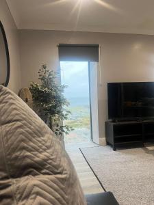 a bedroom with a bed and a flat screen tv at Atlantic beach house in Dog Island