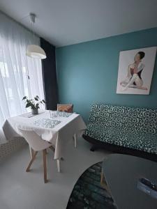 a living room with a white table and a couch at Central Studio Apartment in Pori