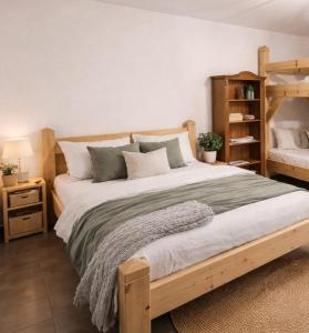 a bedroom with a large wooden bed with pillows at Spreewald Błota Jéwa Ferienwohnung mit Terrasse und Parkplatz in Lübbenau