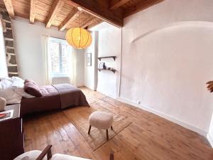 a bedroom with a bed and a chair in it at Maison atypique - Au coeur de la vieille ville in Le Puy-en-Velay