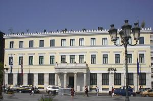 a large white building with people walking in front of it at Acropolis Center Rooms in Athens +18 photos