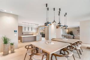 a kitchen and dining room with a table and chairs at De Kompanie in Alken