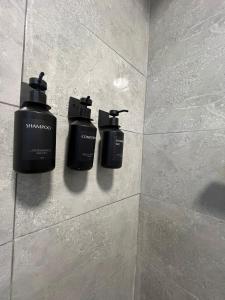 two soap dispensers on the wall of a shower at Sea breeze house in Dog Island +21 photos