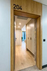 a hallway with a sign on the wall at VIDOK Apartament Olsztyn Premium 204 in Olsztyn +3 photos