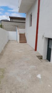 a stairway leading to a white building with a staircase at Casa Grazia Deledda 16 in Orosei +10 photos