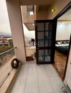 an open door to a room with a balcony at The Retreat Base in Rājpur