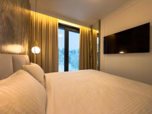 a bedroom with a large bed and a large window at VIDOK Apartament Olsztyn Premium 204 in Olsztyn