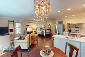 a kitchen and living room with a chandelier at Steps to Riverfront: Dtwn Bluffton Studio! in Bluffton