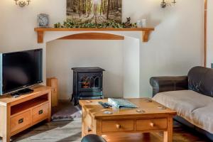 a living room with a couch and a stove at 3 Bed in Littledean oc-g31084 in Little Dean
