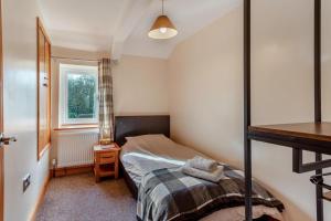 a small bedroom with a bed and a window at 3 Bed in Littledean oc-g31084 in Little Dean