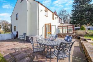 a patio with a table and chairs in front of a house at 3 Bed in Littledean oc-g31084 in Little Dean