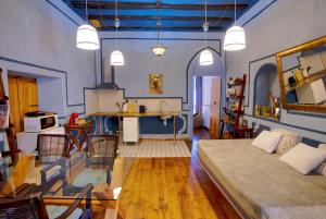 a living room with a large bed and a kitchen at DOMUS Amabilis in Sagunto