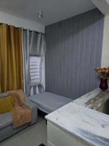 a living room with a couch and a chair at My Flat 1 in Praia