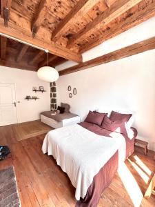 a bedroom with a large bed and wooden ceilings at Maison atypique - Au coeur de la vieille ville in Le Puy-en-Velay