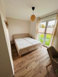 a bedroom with a bed and a large window at Ferienhaus Lounis in Bützow