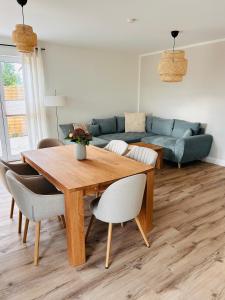 a living room with a wooden table and a couch at Ferienhaus Lounis in Bützow