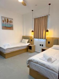 a bedroom with two beds and a window at TEL AVIV - Apartamentos by Luxury Atitlan in San Pedro La Laguna