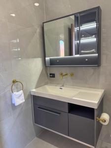 a bathroom with a sink and a mirror at TEL AVIV - Apartamentos by Luxury Atitlan in San Pedro La Laguna +41 photos