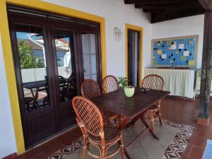 a wooden table and chairs on a patio at Casa das Viagens in Ferreira do Alentejo