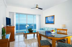 a living room with a couch and a table at Ocean Breeze Nuevo Vallarta in Nuevo Vallarta