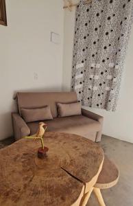 a living room with a table and a couch at Casa Corrupião - Ilha do Ferro - Alagoas in Pão de Açúcar