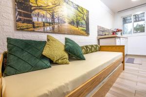 a couch with pillows on it in a room at Nesbehadnes in Had Nes +65 photos