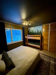 a bedroom with a bed and a large window at Guesthouse Sahanpera in Rovaniemi