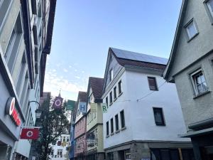 a group of buildings on a city street at CharmÖHR Homes in Öhringen