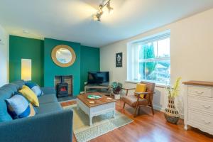 a living room with a blue couch and a fireplace at 2 Bed in Bethesda oc-bow234 in Bethesda
