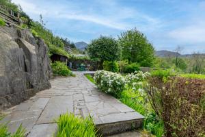 a stone path in a garden with flowers at 2 Bed in Bethesda oc-bow234 in Bethesda