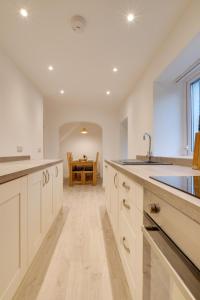 a kitchen with white cabinets and a sink and a table at 2 Bed in Bethesda oc-bow234 in Bethesda