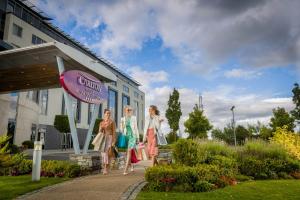 three women walking in front of a building at Carlton Hotel Blanchardstown in Blanchardstown