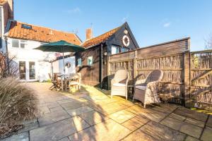 a patio with a table and chairs and an umbrella at 2 Bed in Walberswick oc-h29096 in Walberswick