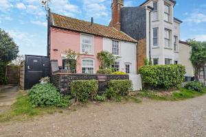 an old house with a gate in front of it at 2 Bed in Walberswick oc-h29096 in Walberswick +14 photos