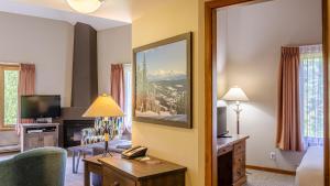 a hotel room with a bedroom with a living room at Cahilty #429 home in Sun Peaks +9 photos