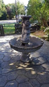 a stone fountain in the middle of a park at Clinker Cottage Garden Apartment - Free Breakfast! in Albany